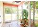 Bright sunroom featuring tile flooring, a ceiling fan, and large windows showcasing the landscape at 111 Rose Water Loop # 111, Myrtle Beach, SC 29588
