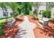 Charming community walking path with benches, lush greenery, and tranquil atmosphere at 111 Rose Water Loop # 111, Myrtle Beach, SC 29588