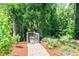 Picturesque walking path with lush greenery, leading to a scenic dock area at 111 Rose Water Loop # 111, Myrtle Beach, SC 29588