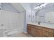 Bright bathroom with a shower-tub combo, vanity with cabinets, and a large mirror at 113A 9Th Ave. S, Surfside Beach, SC 29575