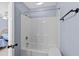 Bathroom featuring neutral tile, a tub-shower combo, and blue painted walls at 113A 9Th Ave. S, Surfside Beach, SC 29575