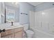 Well-lit bathroom featuring a vanity, toilet, and shower-tub combo at 113A 9Th Ave. S, Surfside Beach, SC 29575