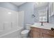 Bathroom with a tub-shower combo and a wood vanity with a modern sink at 113A 9Th Ave. S, Surfside Beach, SC 29575