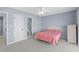 Bedroom with neutral carpet, ceiling fan, and a view into the bathroom at 113A 9Th Ave. S, Surfside Beach, SC 29575