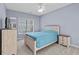 Comfortable bedroom with a large window, ceiling fan, and bed with a blue comforter at 113A 9Th Ave. S, Surfside Beach, SC 29575