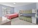 Bedroom with twin beds and bunk beds, featuring a ceiling fan and window at 113A 9Th Ave. S, Surfside Beach, SC 29575