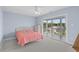 Cozy bedroom featuring a sliding glass door and a bed with a salmon colored comforter at 113A 9Th Ave. S, Surfside Beach, SC 29575