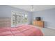 Bedroom featuring a salmon-colored comforter and sliding glass door with exterior views at 113A 9Th Ave. S, Surfside Beach, SC 29575