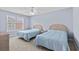Bright bedroom featuring two twin beds, neutral carpet, and a window view at 113A 9Th Ave. S, Surfside Beach, SC 29575