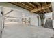 Spacious ground level carport with stairs leading to the main floor, enhanced by the exposed beam ceiling at 113A 9Th Ave. S, Surfside Beach, SC 29575