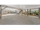 Large open carport and entertainment area with overhead staircase, mature shrubs, and stained support beams at 113A 9Th Ave. S, Surfside Beach, SC 29575