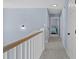 Hallway with carpet, white doors, and a view into the blue-themed bedroom at 113A 9Th Ave. S, Surfside Beach, SC 29575