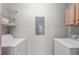 Well-organized laundry room with modern washer and dryer, convenient shelving, and a neutral color scheme at 113A 9Th Ave. S, Surfside Beach, SC 29575
