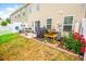 Cozy backyard patio with a grill, patio furniture, red flowers and a small garden box at 1147 Fairway Ln. # 1147, Conway, SC 29526