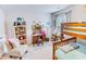 Bright bedroom with a bunkbed, vanity, chair, and decorative shelves at 1147 Fairway Ln. # 1147, Conway, SC 29526