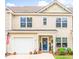 Charming two-story home with a one-car garage, an American flag, and a beautifully decorated entrance at 1147 Fairway Ln. # 1147, Conway, SC 29526