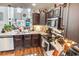 Cozy kitchen with granite countertops, stainless steel appliances, and a breakfast bar overlooking the living area at 1147 Fairway Ln. # 1147, Conway, SC 29526