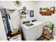 Well-organized laundry room with modern washer and dryer, storage shelves, and a clothes rack at 1147 Fairway Ln. # 1147, Conway, SC 29526