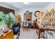 Bright office space with a large dollhouse, an easel with a painting, and a view out the window at 1147 Fairway Ln. # 1147, Conway, SC 29526