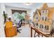 Bright office space with a large dollhouse, an easel with a painting, and a view out the window at 1147 Fairway Ln. # 1147, Conway, SC 29526