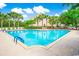 Large community pool surrounded by palm trees and lounge chairs perfect for relaxing and enjoying the sunshine at 1147 Fairway Ln. # 1147, Conway, SC 29526