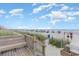 Scenic beach access with wooden walkway and bench, leading to a lively oceanfront at 1205 S Ocean Blvd. # 20609, Myrtle Beach, SC 29577
