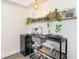 Modern kitchenette features sink, mini fridge, cooktop and a shelf with plants at 1205 S Ocean Blvd. # 20609, Myrtle Beach, SC 29577