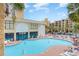 Inviting outdoor pool area with ample lounge chairs, lush landscaping, and building views at 1205 S Ocean Blvd. # 20609, Myrtle Beach, SC 29577