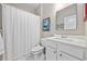 A well-lit bathroom features a shower with curtain, a white toilet, and a mirror over the sink at 125 Mountain Ash Ln., Myrtle Beach, SC 29579