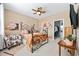 Bright bedroom with decorative metal bed frame, ceiling fan, and an ensuite closet at 125 Mountain Ash Ln., Myrtle Beach, SC 29579