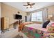 Cozy bedroom features a colorful bedspread, a ceiling fan, and a view of the outdoors at 125 Mountain Ash Ln., Myrtle Beach, SC 29579