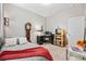 Comfortable bedroom with a gray quilt, grandfather clock, and a desk with computer at 125 Mountain Ash Ln., Myrtle Beach, SC 29579