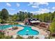Community pool with barn-themed clubhouse, playground, and surrounding trees at 125 Mountain Ash Ln., Myrtle Beach, SC 29579