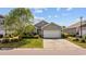Charming single-story home featuring a well-manicured lawn, gray siding and a two-car garage at 125 Mountain Ash Ln., Myrtle Beach, SC 29579