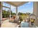 A well-decorated screened-in patio features comfortable seating, plants, and a backyard view at 125 Mountain Ash Ln., Myrtle Beach, SC 29579