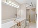 Bright bathroom with a large mirror, white vanity, and walk-in shower at 1314 Holly Dr., North Myrtle Beach, SC 29582