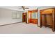 Bedroom with carpet floors, wood paneling, large closets, and a ceiling fan at 1314 Holly Dr., North Myrtle Beach, SC 29582
