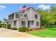 Charming gray home featuring shingle siding, an American flag, and blue door at 1314 Holly Dr., North Myrtle Beach, SC 29582