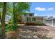 View of the back exterior featuring lush landscaping and brick chimney at 1314 Holly Dr., North Myrtle Beach, SC 29582