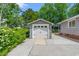 Detached garage with white door and adjacent walkway lined with greenery at 1314 Holly Dr., North Myrtle Beach, SC 29582