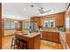 A traditional kitchen featuring wood cabinets, granite countertops, stainless steel appliances, and a central island with bar seating at 1314 Holly Dr., North Myrtle Beach, SC 29582