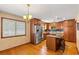 A traditionally-styled kitchen with wood cabinets, stainless steel refrigerator, granite countertops, and an island with seating at 1314 Holly Dr., North Myrtle Beach, SC 29582