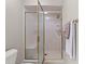 Bathroom shower with gold trim and built-in seat and shelves, next to the toilet at 1314 Holly Dr., North Myrtle Beach, SC 29582