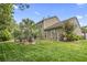 Expansive backyard featuring a lush lawn, mature trees, and a screened-in porch at 1416 Castleberry Pl., Myrtle Beach, SC 29588