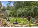 Well-maintained backyard with lush lawn, patio, and mature trees, creating a private retreat at 1416 Castleberry Pl., Myrtle Beach, SC 29588
