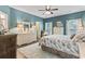 Bedroom with blue walls, ceiling fan, coastal decor, and white dressers and nightstands at 1416 Castleberry Pl., Myrtle Beach, SC 29588