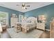 Cozy bedroom with coastal decor, wood floors, and ample natural light from the windows at 1416 Castleberry Pl., Myrtle Beach, SC 29588