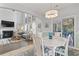 Dining room with coastal decor, white table, and chairs next to the living room and sliding glass doors at 1416 Castleberry Pl., Myrtle Beach, SC 29588