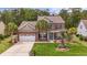Charming two-story brick home with well-maintained landscaping and a welcoming front porch at 1416 Castleberry Pl., Myrtle Beach, SC 29588