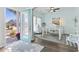 Bright home office with a modern glass desk, light blue walls and dark wood floors at 1416 Castleberry Pl., Myrtle Beach, SC 29588